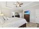 Comfortable main bedroom featuring a tray ceiling, ceiling fan, and ensuite bathroom at 18796 Obregan Dr, Spring Hill, FL 34610