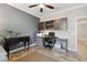 Office space with a gray accent wall, built-in shelving, and a ceiling fan at 18796 Obregan Dr, Spring Hill, FL 34610