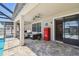 Relaxing covered patio with comfortable seating, a vintage refrigerator, and pool views at 18796 Obregan Dr, Spring Hill, FL 34610