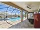 Beautiful screened-in pool area with patio seating and scenic water views at 18796 Obregan Dr, Spring Hill, FL 34610