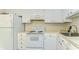 Bright kitchen with white appliances, cabinets, and ample counter space at 1881 N Hercules Ave # 1303, Clearwater, FL 33765
