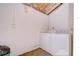 A utilitarian laundry room with a washer and dryer and exposed ceiling at 1881 N Hercules Ave # 1303, Clearwater, FL 33765