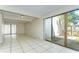 Spacious living room featuring tile flooring, sliding glass doors, and ample natural light at 1881 N Hercules Ave # 1303, Clearwater, FL 33765