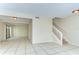 Spacious living area featuring tile floors, a staircase, and large sliding glass doors for natural light at 1881 N Hercules Ave # 1303, Clearwater, FL 33765