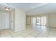 Bright living room featuring tile floors, a closet, and a sliding door to the outside at 1881 N Hercules Ave # 1303, Clearwater, FL 33765