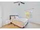 Bright bedroom with neutral carpet, a ceiling fan and a view of the trees at 20121 Bending Creek Pl, Tampa, FL 33647
