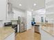 Modern kitchen features stainless steel appliances, granite countertops, and open layout at 20121 Bending Creek Pl, Tampa, FL 33647