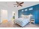 The bright main bedroom features a stylish accent wall, modern fixtures and en-suite bath at 20121 Bending Creek Pl, Tampa, FL 33647