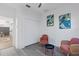 Cozy sitting area with two chairs, leaf paintings and a closet by the entrance at 20121 Bending Creek Pl, Tampa, FL 33647