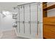 Spacious walk-in closet features custom shelving, wooden cabinets and modern design at 20121 Bending Creek Pl, Tampa, FL 33647