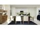 Dining area featuring modern decor, a sleek table, and views into the connected living space at 2292 Blue Grosbeak Pl, Wimauma, FL 33598