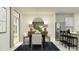 Bright dining room with a modern table, seating for six, and stainless steel refrigerator at 2292 Blue Grosbeak Pl, Wimauma, FL 33598