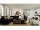 Open-concept living room with a plush blue sofa, stylish decor, and a view to the kitchen at 2292 Blue Grosbeak Pl, Wimauma, FL 33598
