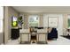 Comfortable living room with a sectional sofa, modern artwork, and natural light from the window at 2292 Blue Grosbeak Pl, Wimauma, FL 33598