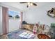 Bright bedroom features a ceiling fan, wood floors, a cozy bed, and a window with natural light at 2366 Covington Dr, Clearwater, FL 33763