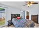 Bedroom features wood floors, ceiling fan, and two windows at 2366 Covington Dr, Clearwater, FL 33763