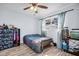 Bedroom with a large window, built in cabinet, and wood-look laminate flooring at 2366 Covington Dr, Clearwater, FL 33763
