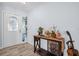 Inviting foyer with decorative table, white front door, and a guitar at 2366 Covington Dr, Clearwater, FL 33763