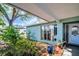Charming front porch featuring a large window, manicured garden, and a decorative wind chime at 2366 Covington Dr, Clearwater, FL 33763