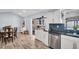 View of kitchen with stainless steel dishwasher, bar seating, and tiled backsplash at 2366 Covington Dr, Clearwater, FL 33763