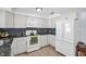 Clean kitchen with white cabinetry, stone countertops, and stainless steel appliances at 2366 Covington Dr, Clearwater, FL 33763