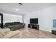 A comfortable living room featuring a large window, a sofa, and a TV at 2366 Covington Dr, Clearwater, FL 33763
