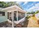 Exterior view of the screened-in patio featuring a grill, Adirondack chairs, and a view of the yard at 2366 Covington Dr, Clearwater, FL 33763