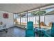 Screened lanai features wood tile floors, seating, and views of the backyard at 2366 Covington Dr, Clearwater, FL 33763
