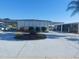 Charming single-story home featuring a spacious carport and beautiful landscaping at 267 Colonial Blvd # 9, Palm Harbor, FL 34684