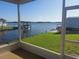 Relaxing screened-in porch with scenic water views, including a boat dock and lush green lawn at 267 Colonial Blvd # 9, Palm Harbor, FL 34684