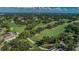 Stunning aerial view of a lush golf course community with mature trees and manicured greens at 2700 Westchester N Dr, Clearwater, FL 33761