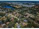 Real estate view of a quiet neighborhood with mature trees, lush greenery and a nearby lake at 2700 Westchester N Dr, Clearwater, FL 33761