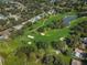 Scenic aerial view of a lush golf course, lake, homes, and a tranquil pond at 2700 Westchester N Dr, Clearwater, FL 33761