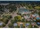 An aerial view shows a vibrant community with tennis courts, a pool, a golf course and manicured landscaping at 2700 Westchester N Dr, Clearwater, FL 33761