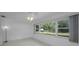 Bright bedroom featuring a ceiling fan and large windows with backyard views at 2700 Westchester N Dr, Clearwater, FL 33761