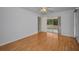 Bedroom featuring wood-look flooring, a ceiling fan, and a glass sliding door at 2700 Westchester N Dr, Clearwater, FL 33761