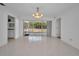Bright dining room with tile flooring, chandelier, and sliding glass doors leading to the patio at 2700 Westchester N Dr, Clearwater, FL 33761