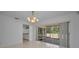Dining area showcasing tile floors and sliding glass door access to the outdoor patio space at 2700 Westchester N Dr, Clearwater, FL 33761