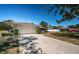 Well-maintained single-story home featuring an attached garage, a spacious driveway, and a landscaped front yard at 2700 Westchester N Dr, Clearwater, FL 33761