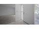 Bright entryway with tiled floor, white walls, and a storm door at 2700 Westchester N Dr, Clearwater, FL 33761