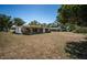 Back exterior of house with a screened in porch, set on a large property at 2700 Westchester N Dr, Clearwater, FL 33761