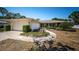 Charming single-story home with a well-manicured lawn, mature trees, and an attached two-car garage at 2700 Westchester N Dr, Clearwater, FL 33761