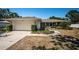 Well-maintained single-story home with an attached garage, complemented by lush landscaping and a welcoming walkway at 2700 Westchester N Dr, Clearwater, FL 33761