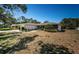 Single story home featuring a well-maintained front yard, attached garage, and mature landscaping at 2700 Westchester N Dr, Clearwater, FL 33761