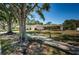 Charming single-story home with mature trees, manicured lawn, and inviting walkway at 2700 Westchester N Dr, Clearwater, FL 33761