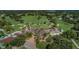 Aerial shot of a golf course and clubhouse offering a luxurious and scenic recreational experience at 2700 Westchester N Dr, Clearwater, FL 33761