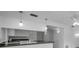 Updated kitchen showcasing granite countertops, pendant lighting, and white cabinetry at 2700 Westchester N Dr, Clearwater, FL 33761