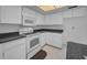 Clean kitchen with white appliances, cabinets, and neutral countertops at 2700 Westchester N Dr, Clearwater, FL 33761