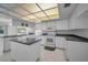 Spacious kitchen with white cabinets, stone countertops and tiled floors at 2700 Westchester N Dr, Clearwater, FL 33761