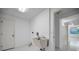 Bright laundry room with utility sink and convenient access to additional rooms, offering functionality and ease for chores at 2700 Westchester N Dr, Clearwater, FL 33761